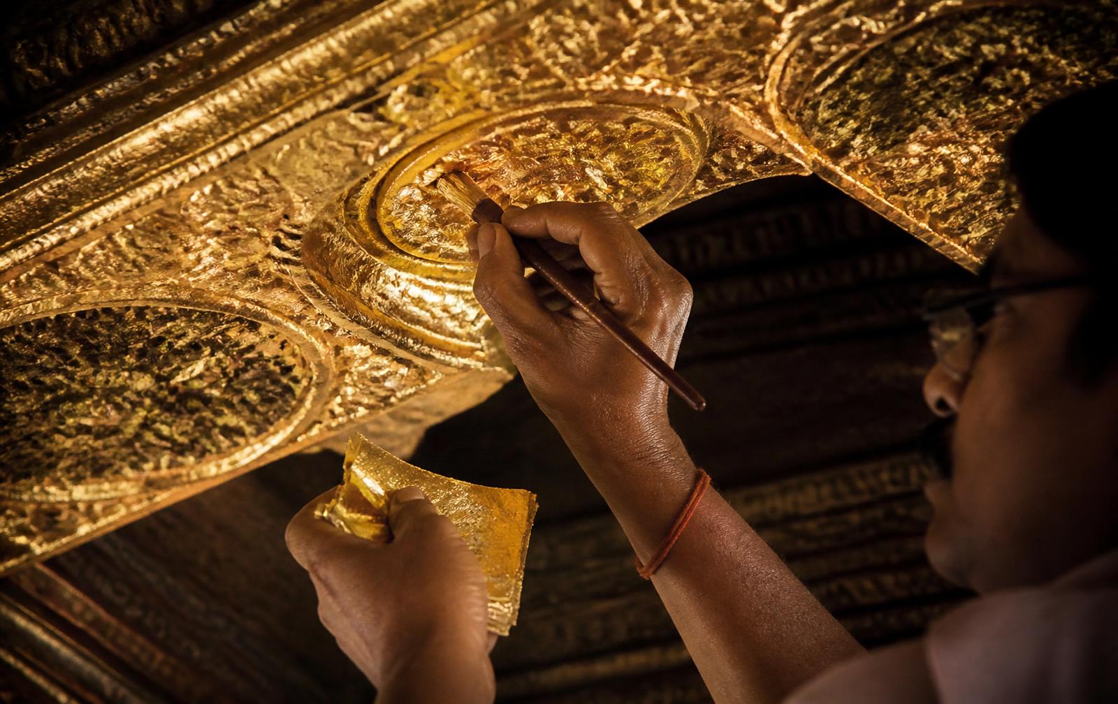 Master gilder applying 24K gold leaf to an ornate ceiling in Jaipur — Jaipur Gold Leaf